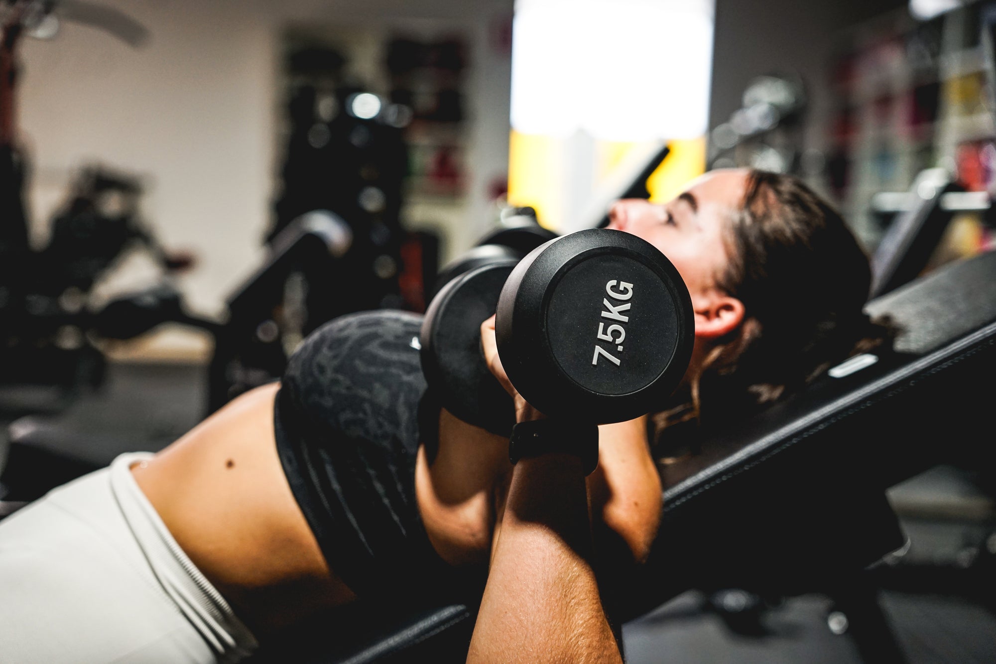 Girl using dumbbells at Fitness Hero